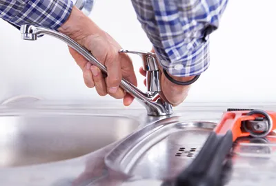 Plumber installing a plumbing fixture in a Sanford, FL home