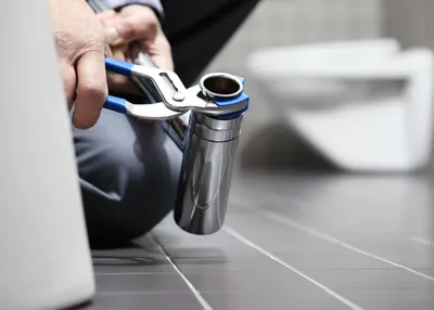 Plumber repairing a leaking pipe in Sanford, FL