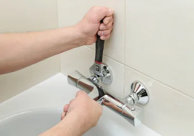 Plumber repairing residential plumbing in Sanford, FL